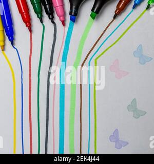 Colored stripes and colorful butterflies made by felt-tip pens and highlighters whose tip can be seen Stock Photo