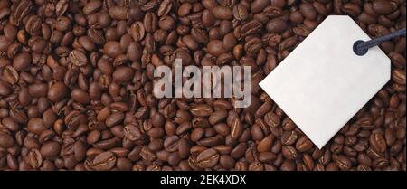 Top view of a bunch of roasted coffee beans. Panoramic image with Label for your individual text. Stock Photo
