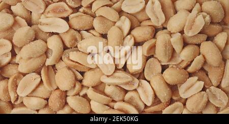Salted peanuts. Panoramic background. Stock Photo