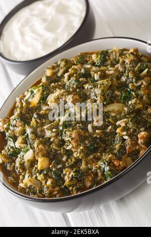 Kiymali Ispanak Spinach with ground meat, onions and rice closeup in the bowl on the table. Vertical Stock Photo