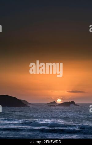 An intense spectacular sunset over Fistral Bay in Newquay in Cornwall. Stock Photo