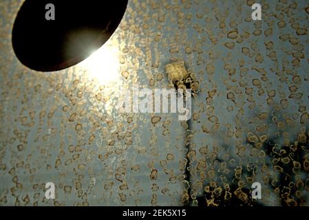 The sun behind a sticker on a dirty train window creates the effect of a spotlight in London, UK Stock Photo