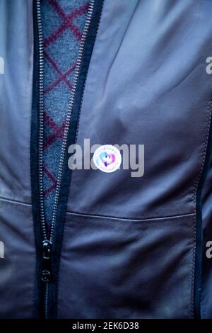 Man With Covid Vaccine Sticker on Jacket Stock Photo