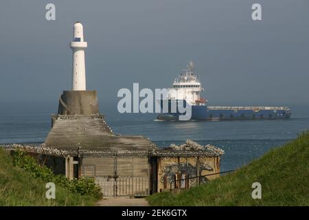 Aberdeen Harbour South Breakwater Lighthouse and freighter Stock Photo