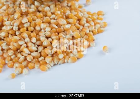 Heap of raw popcorn grains on white background Stock Photo