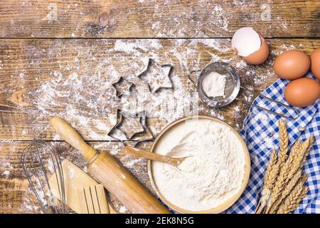 Frame of baking and cooking pastry or cake with ingredients and utensils. Eggs, flour and wheat on rustic wooden background with copy space for text, Stock Photo