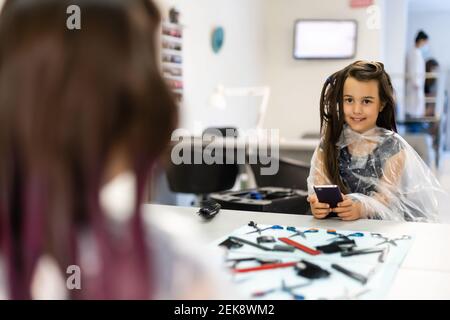 little girl dyes her hair purple in a hairdressing salon Stock Photo