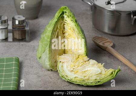 Fresh raw healthy pointed cabbage and a piece close up Stock Photo