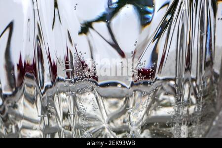 Festive abstract background with rainbow multi-color structure, abstract image of a champagne glass. Front view, close-up. Stock Photo