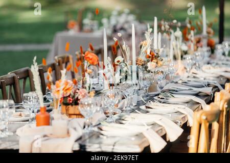 Luxury wedding reception, dining table setup with decoration on rustic wooden table Stock Photo