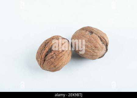 Two whole healthy walnuts on a white background Stock Photo