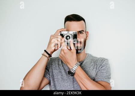 Young man holding vintage camera Stock Photo