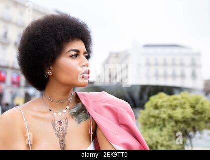 Thoughtful young woman looking away outdoors Stock Photo
