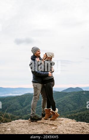 Happy couple hugging each other at viewpoint Stock Photo
