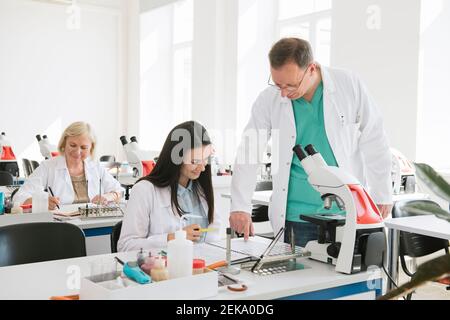 Students and teacher working in science class Stock Photo