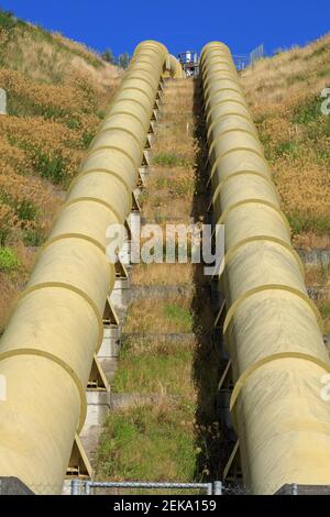 Giant metal pipelines running down a hillside. These supply water to a hydroelectric power plant at Ruahihi, New Zealand Stock Photo