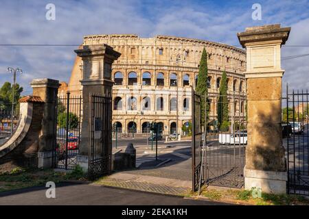 Italy, Rome, Colosseum, Oppian Hill Park gate and ancient amphitheatre Stock Photo