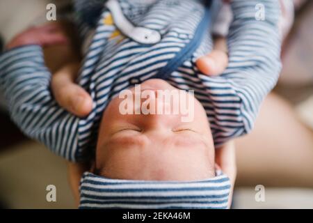 Woman holding cute sleeping baby boy Stock Photo