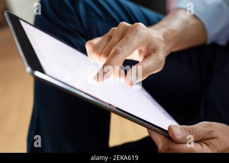 Close-up of businessman using digital tablet Stock Photo
