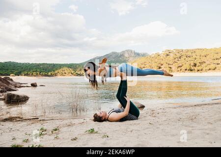 Young women doing acroyoga Stock Photo