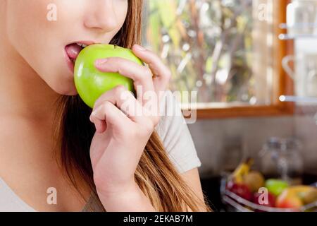 Close up of a teenage girl eating an apple Stock Photo