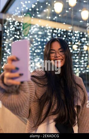 Portrait of young woman sits on kitchen floor with telephone, takes selfie  on smartphone with app filters, poses for photo on mobile phone 35811549  Stock Photo at Vecteezy
