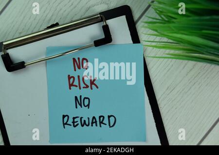 No Risk No Reward write on sticky notes isolated on Wooden Table. Stock Photo