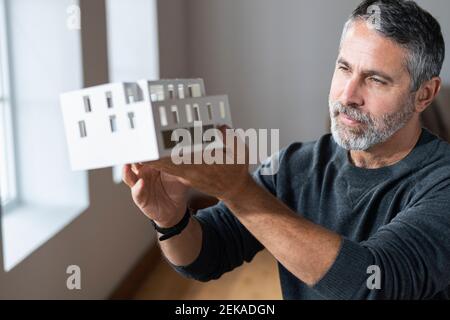 Architect holding architectural model while standing at home Stock Photo