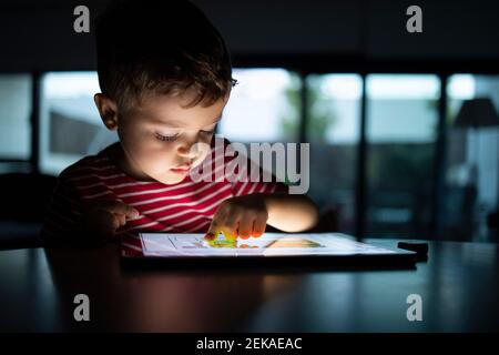 Boy using digital tablet at home Stock Photo