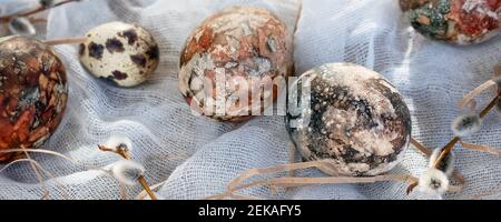 Easter composition - Easter eggs painted with natural dyes on a wooden table. Stock Photo