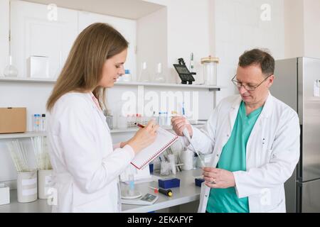 Researchers in white coats working in lab Stock Photo