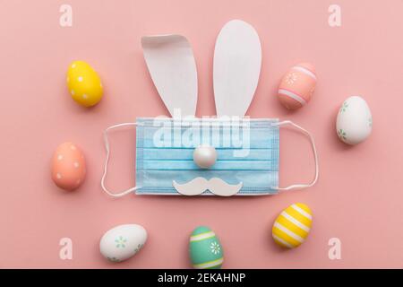 Coronavirus Easter bunny face made from rabbit ears and a protective face mask Stock Photo