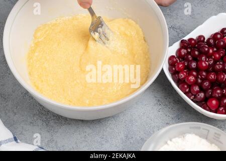 Making a dough for a sweet cranberry pie. Mixing butter and sugar. Stock Photo