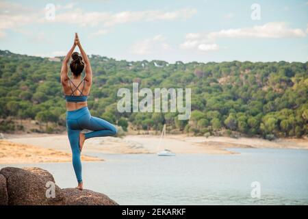 Young woman practicing tree pose Stock Photo