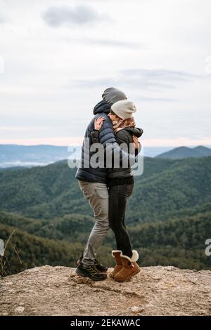 Affectionate couple hugging each other at viewpoint Stock Photo