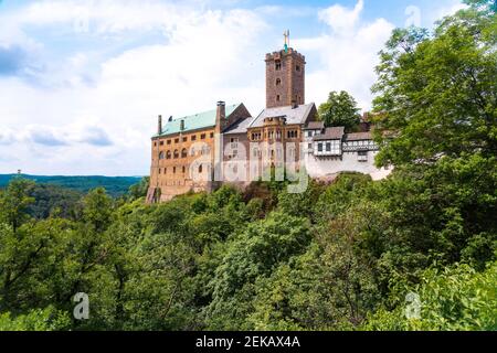 Wartburg Castle by Thuringer forest against cloudy sky at Eisenach, Germany Stock Photo