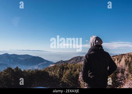 Man in warm clothing looking at view during winter Stock Photo