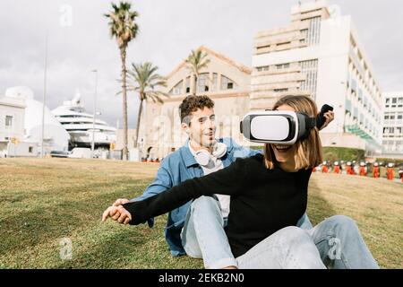 Couple using virtual reality goggles in city Stock Photo