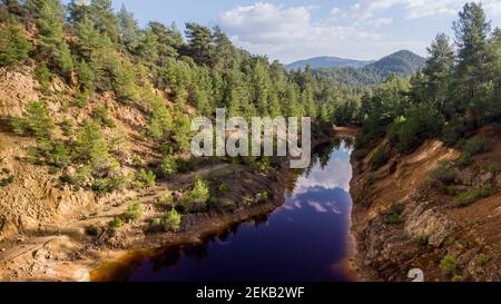 Red lake at abandoned open-pit copper mine near Vretsia, Cyprus. Its odd color derives from high levels of toxic chemicals Stock Photo