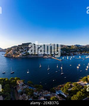 Spain, Balearic Islands, Andratx, Helicopter view of boats sailing near shore of coastal town Stock Photo