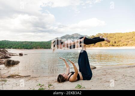 Young female friends doing acroyoga Stock Photo