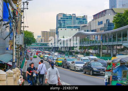 Bangkok, Thailand - 01.25.2018: Central street in the evening city metropolis with traffic jams and pedestrians. Stock Photo