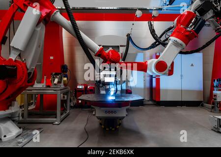 Automatic robots welding metal in factory Stock Photo