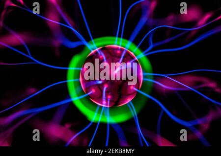 Glowing plasma ball. Scientific photo of high frequency current generator. Could be used as coronavirus micro photo