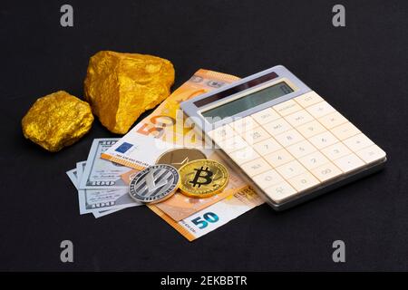 Exchange objects in global stock markets concept: Gold pieces, crypto currency and a calculator lying on EURO and US dollar money banknotes. Finance Stock Photo