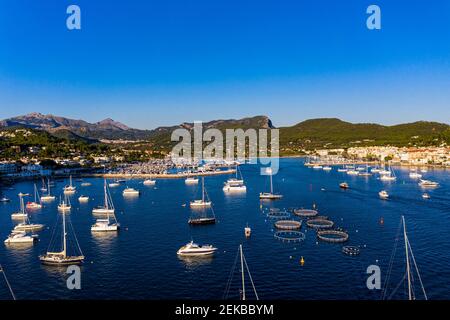 Spain, Balearic Islands, Andratx, Helicopter view of boats sailing near shore of coastal town Stock Photo