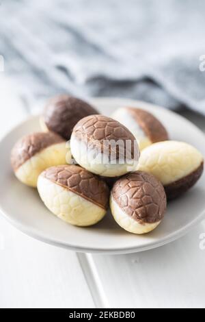Chocolate easter eggs. Sweet candy eggs on white table. Stock Photo