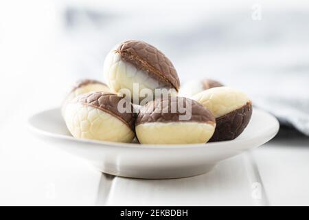 Chocolate easter eggs. Sweet candy eggs on white table. Stock Photo