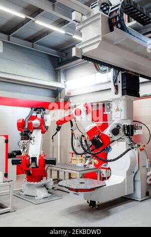 Modern welding robots in industrial building Stock Photo