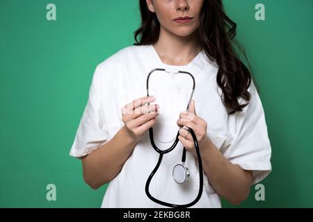 Female doctor holding stethoscope in studio Stock Photo